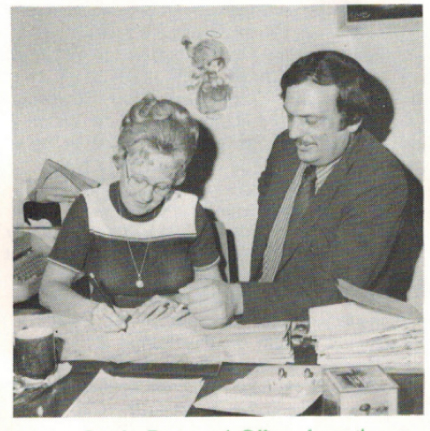 Marjorie Swick, Personnel Officer from the Department of Licensing and Regulation, the first state employee to sign an enrollment form, with Plan Administrator Duane Marlan (1975).